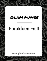 A product label for 'Forbidden Fruit' perfume and body oil by Glam Fumes, featuring a white rectangle with the brand name at the top and the product name at the bottom, set against a background of black roses.